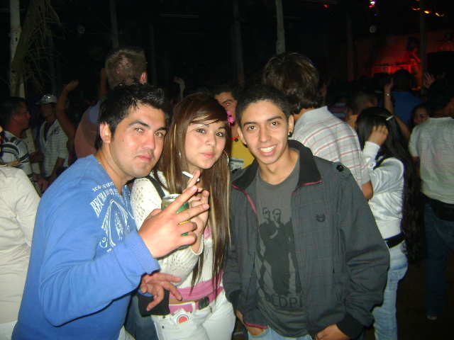three young people pose together at a party
