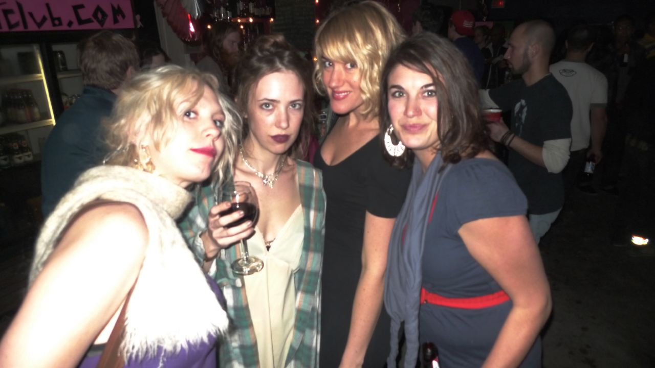 a group of women pose for a po while wearing short dresses