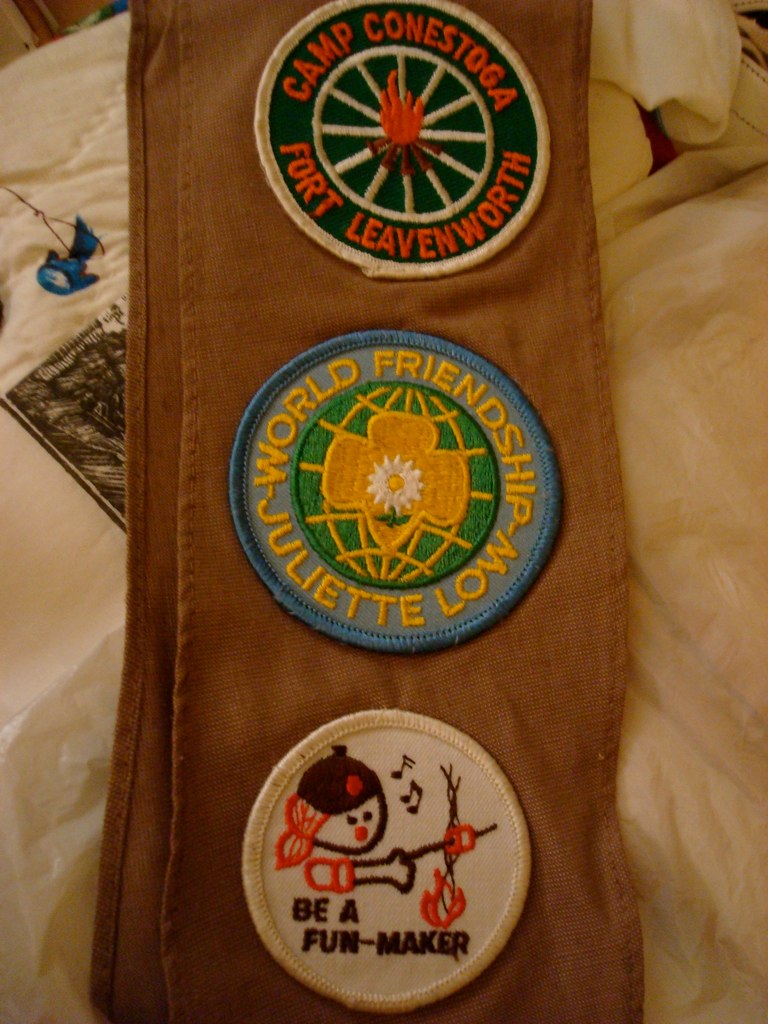 a pair of handbags with patches attached to it