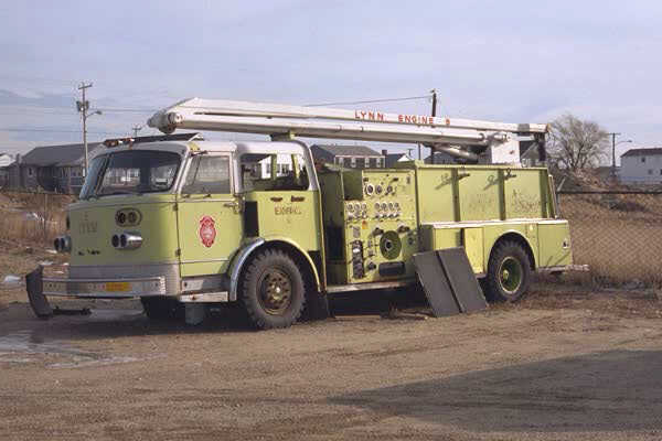 a large yellow fire truck parked in a field
