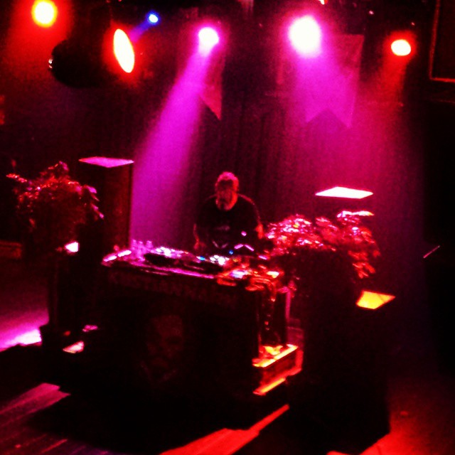 dj in front of colorful light on stage