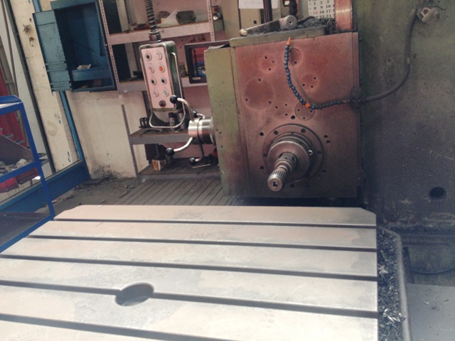 a large machine on a work bench inside of a factory