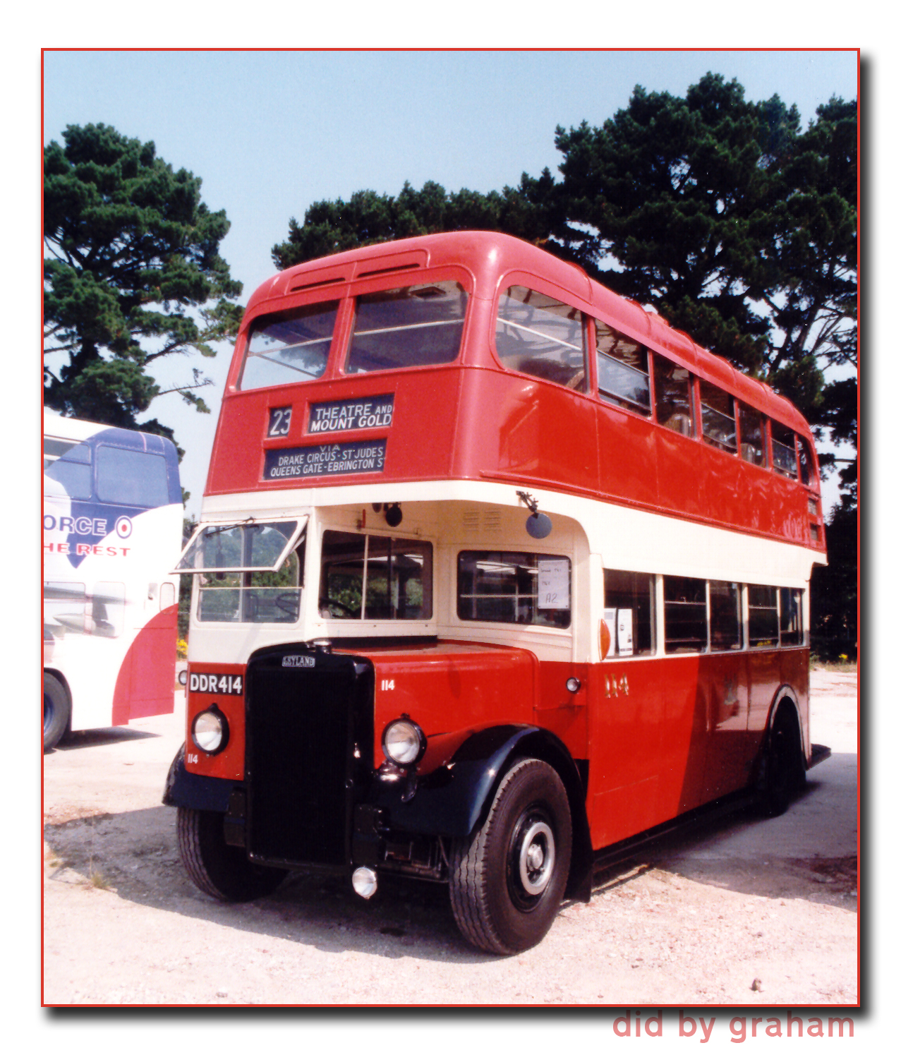 a double decker bus is parked in the gravel