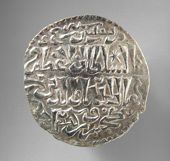 a silver coin with different writing on it