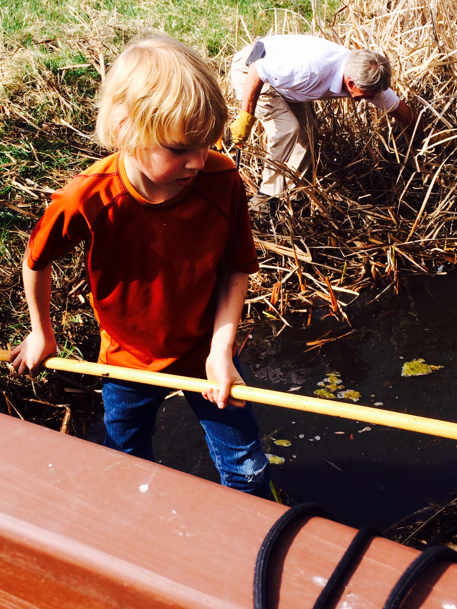 two boys fishing on the surface of water