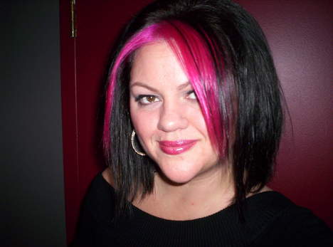 a woman with bright pink hair with pink highlights