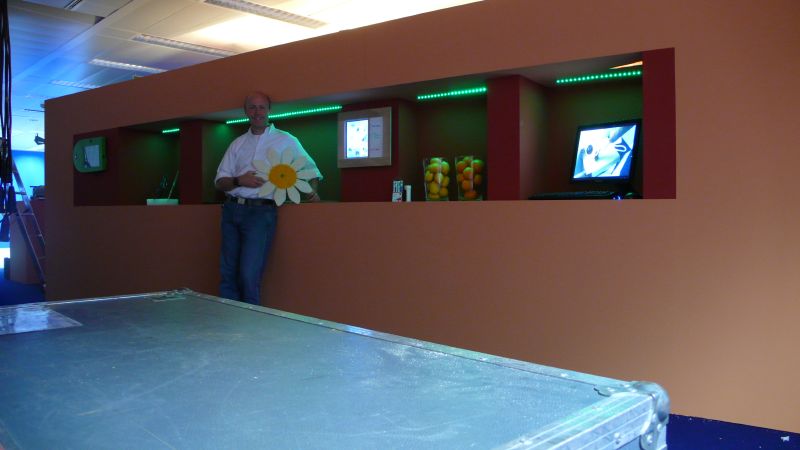 a man with a daisy stands next to a large room