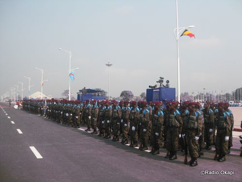 a large group of uniformed men in uniform marching down a road