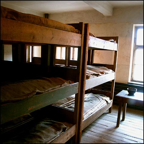 the bunk beds are neatly made and have no mattresses