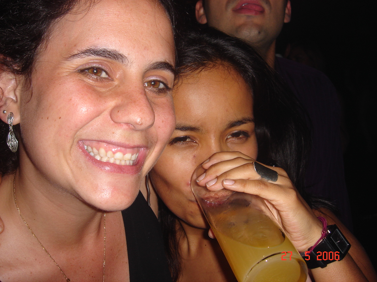 a couple of women drinking and taking a po