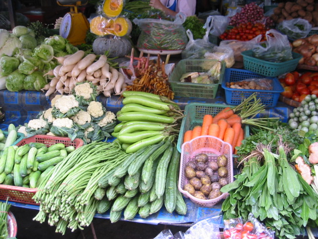 various kinds of fruits and vegetables displayed at a farmer's market