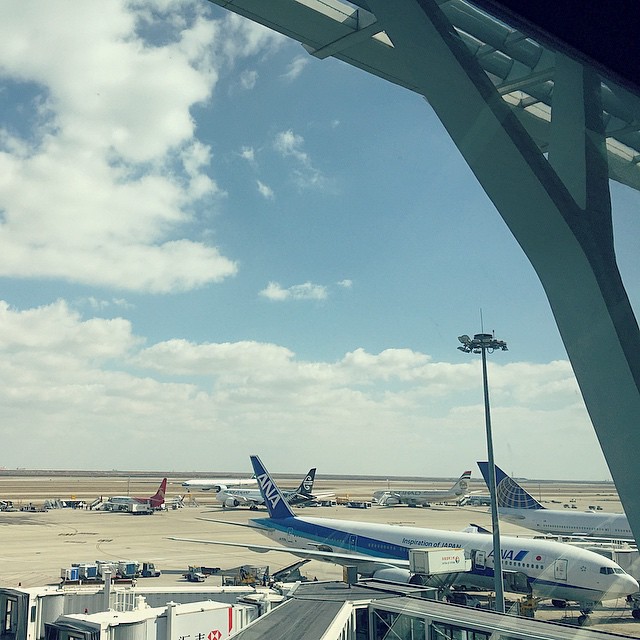 airplanes sit parked on the tarmac at an airport