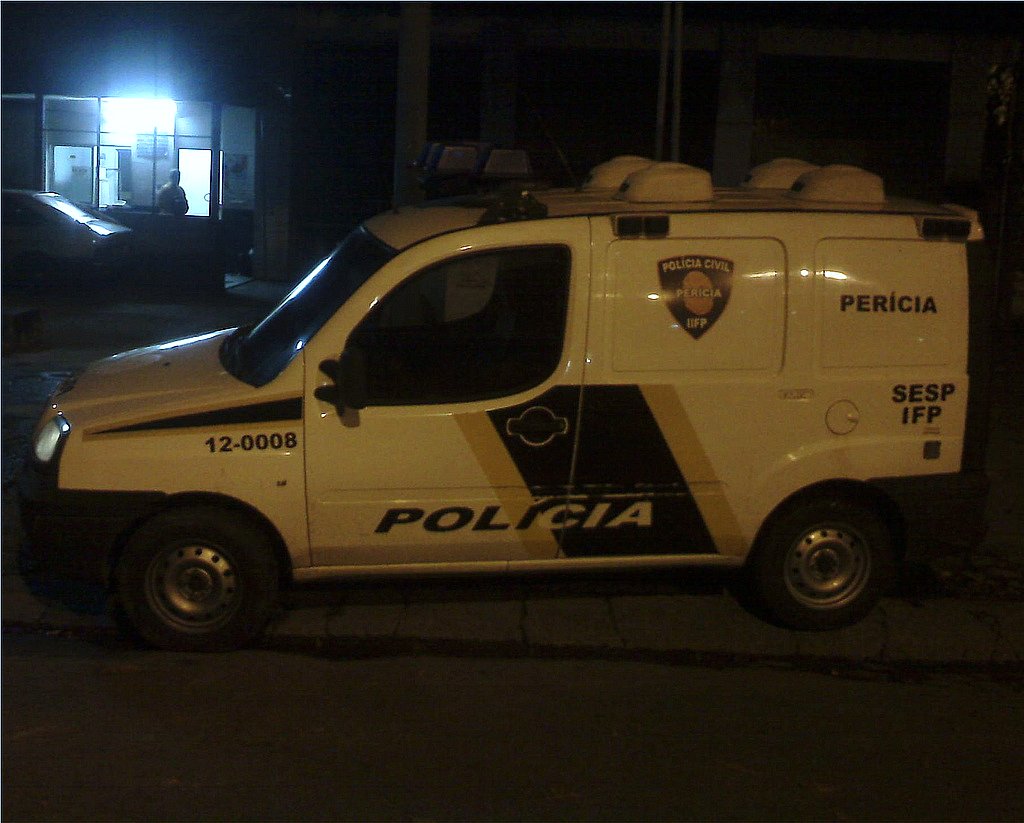 a white police van parked in front of a building