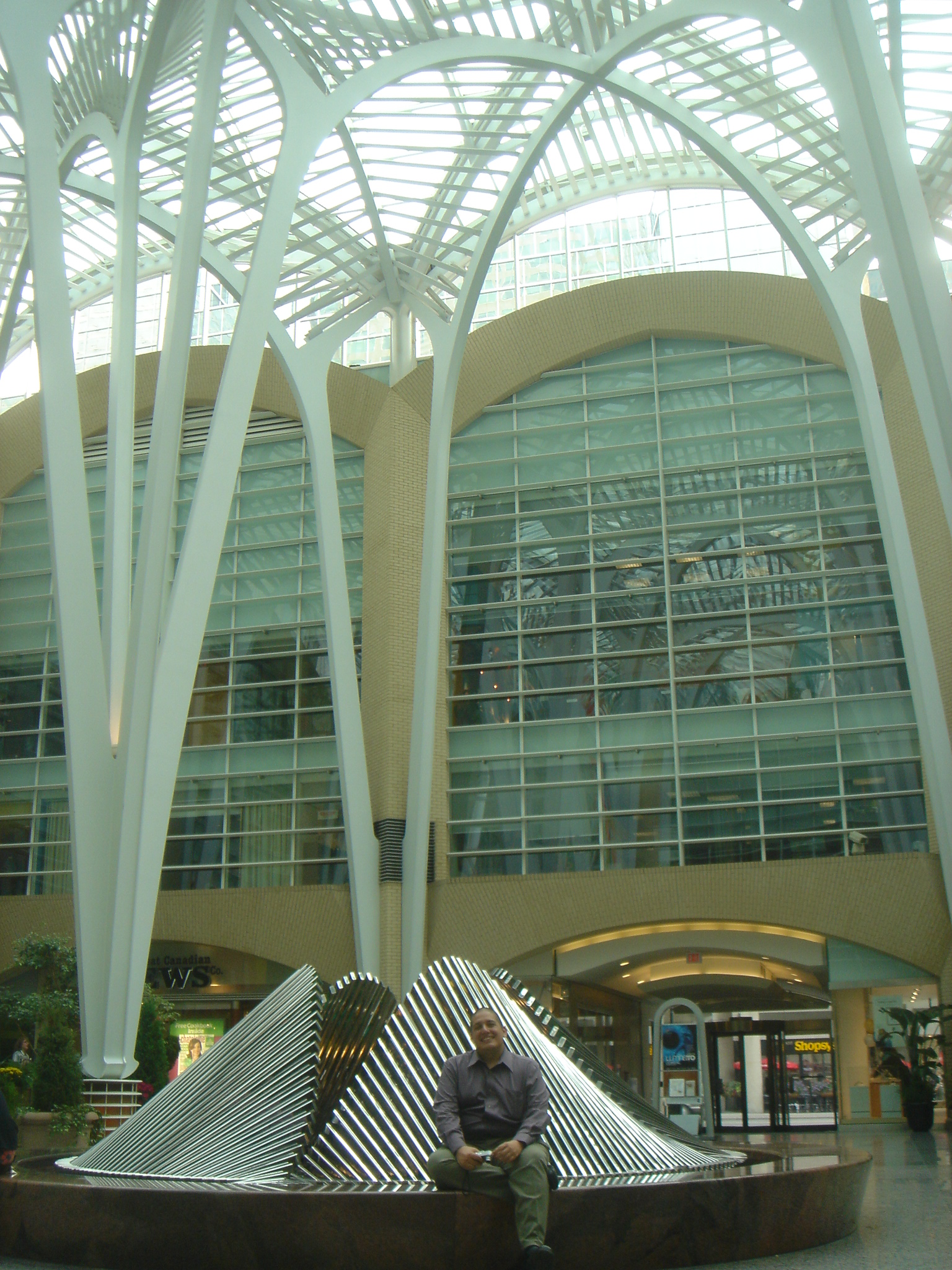 a man is sitting in front of some sculptures