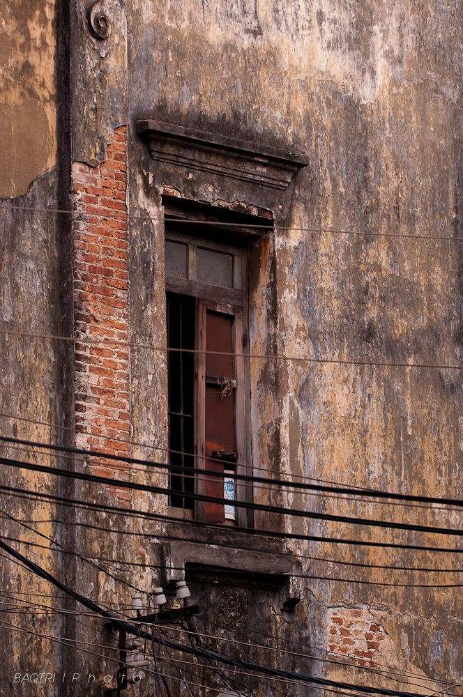 the front of an old building with power lines