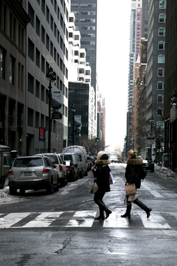 two women crossing an empty city street