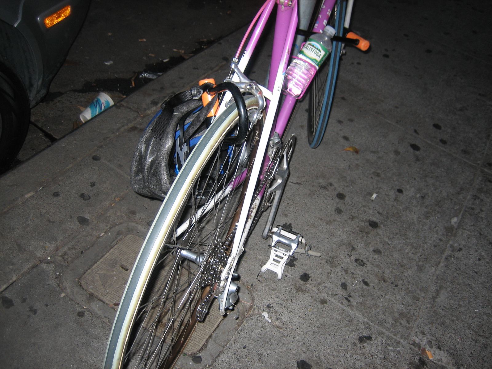 a purple bike is parked on the sidewalk
