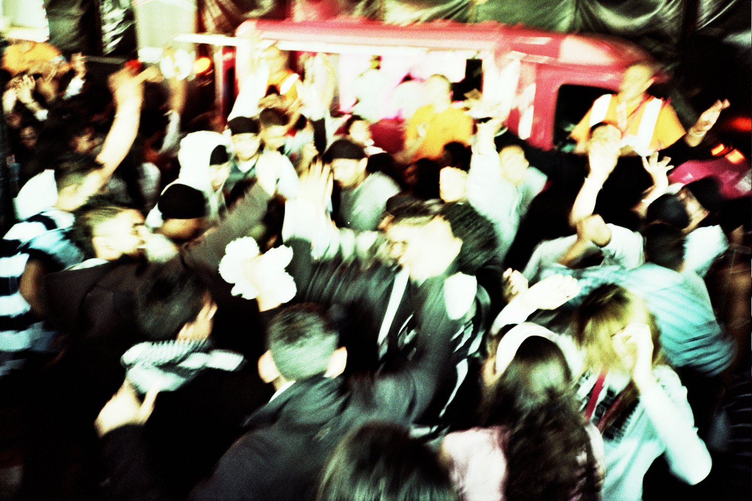 an image of a crowd of people standing in front of a bus