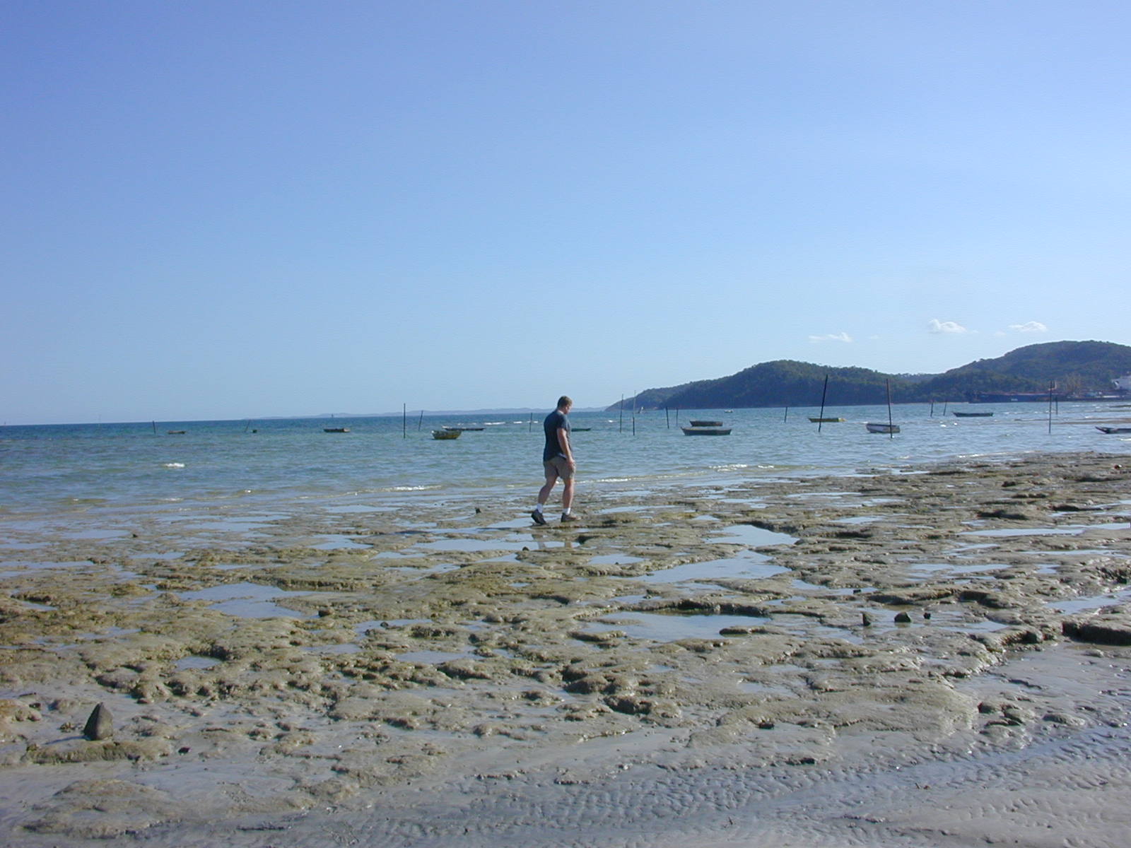 a man is walking across some shallow water