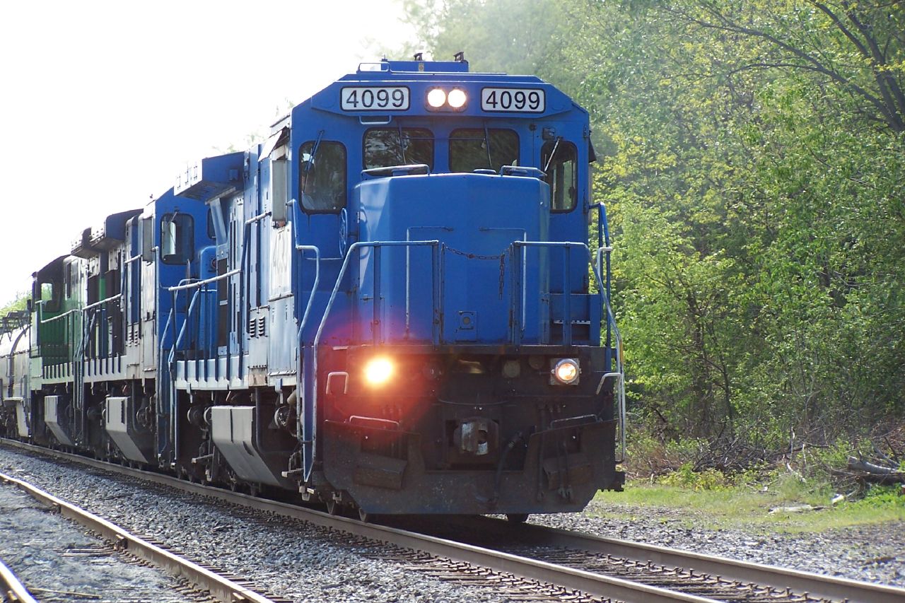 a train riding along the railroad tracks next to trees