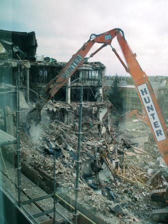a construction crane removing rubble from building