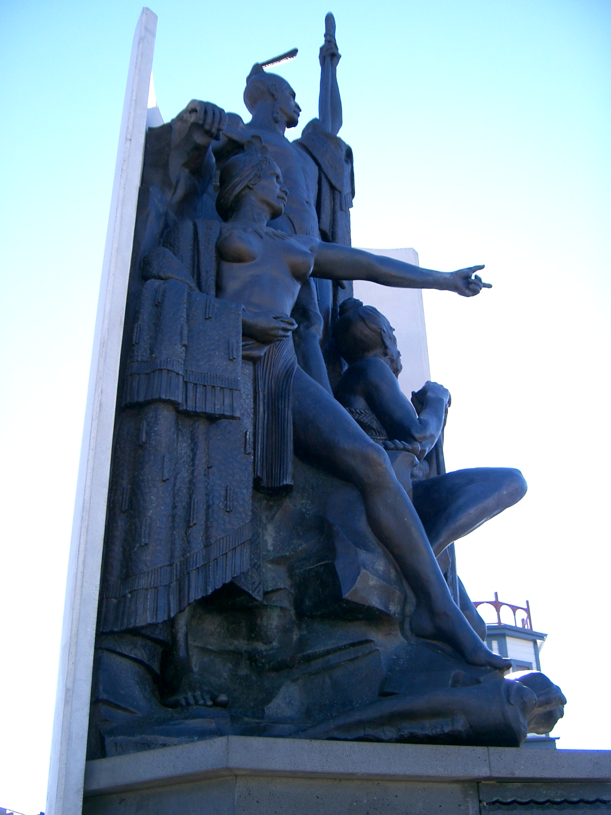 an old bronze statue sitting on top of a monument