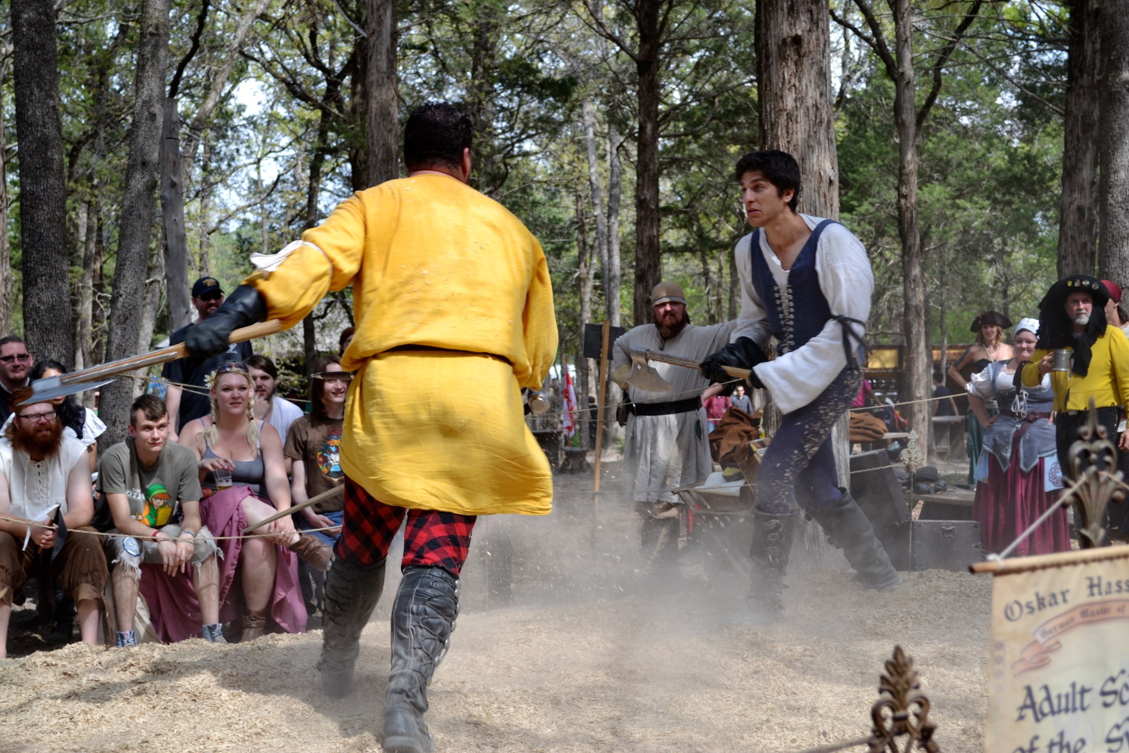 people in yellow costumes playing a medieval battle