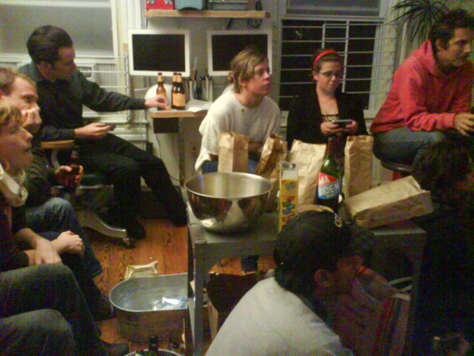 a group of young men sitting in a kitchen