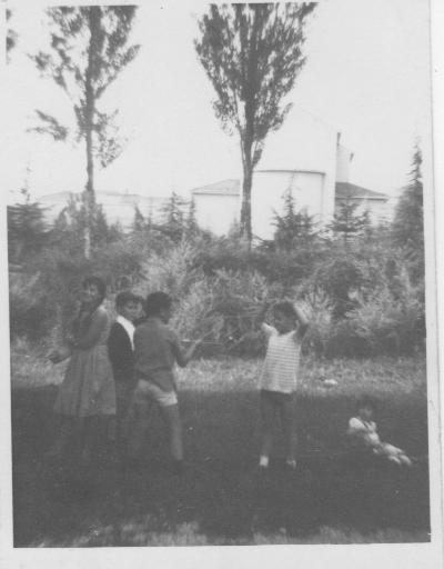 an old po of two women and a boy in a yard
