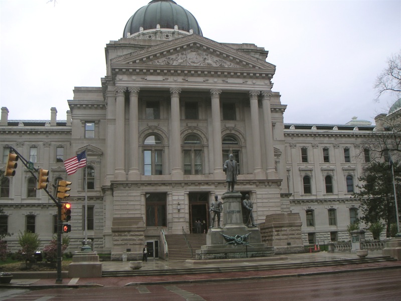 a courthouse with large pillars, two stories, and a dome