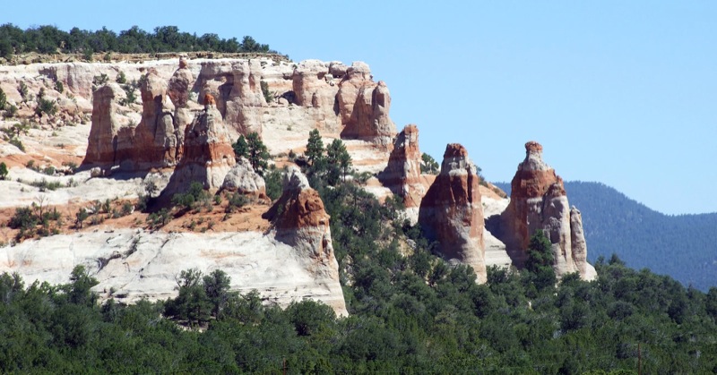 some large rock formations with green trees on top of them