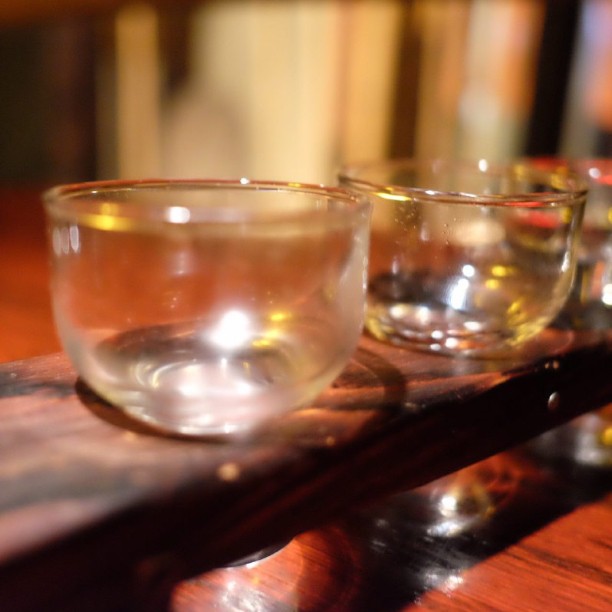 four glass cups sitting on top of a wooden table