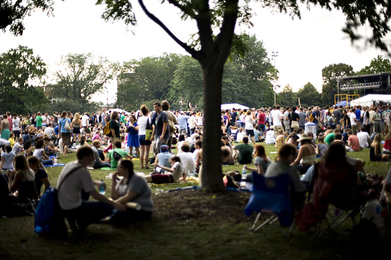 there are many people sitting on the grass