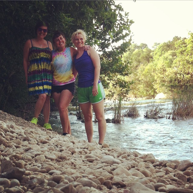 a couple of ladies that are standing on the beach