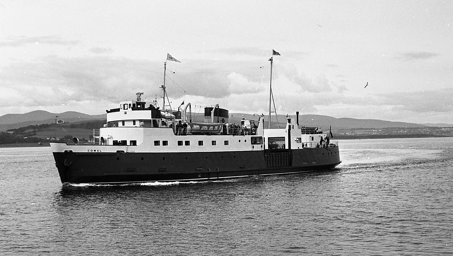 black and white pograph of a boat traveling in water