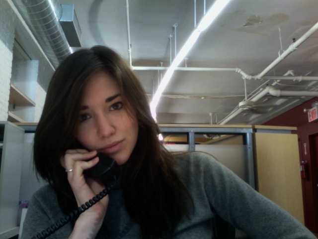 a woman in the office talking on the phone