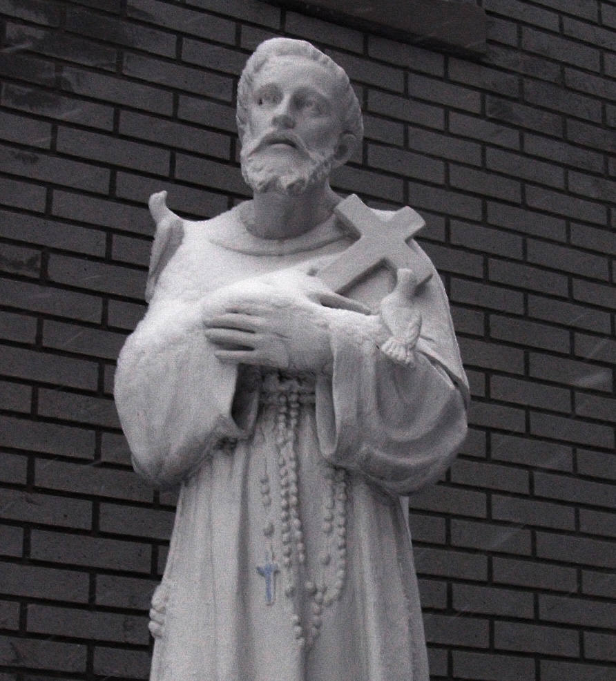 a statue of a man holding a cross