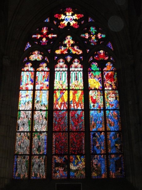 colorful stain glass window in a castle that is very tall