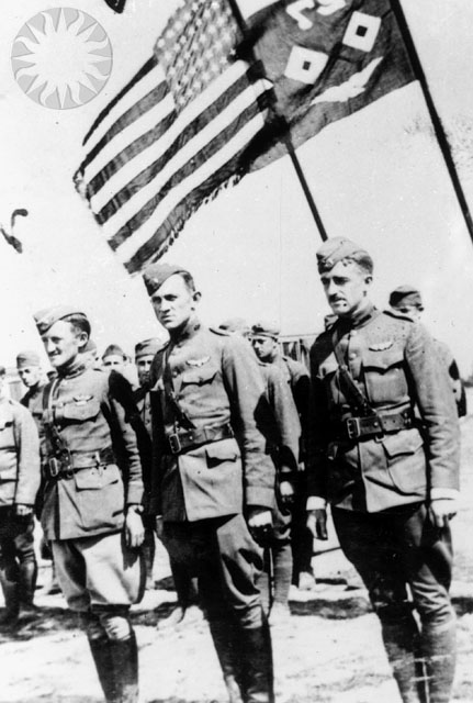men in uniform and some holding american flags