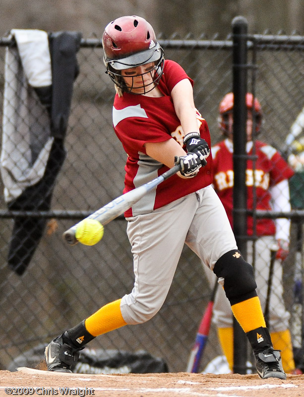 a woman hits the ball at an organized game