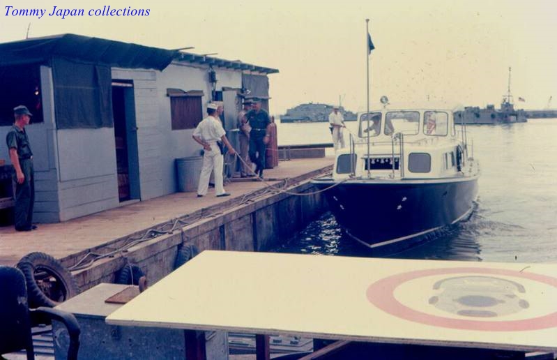 some people on a dock and one in a boat