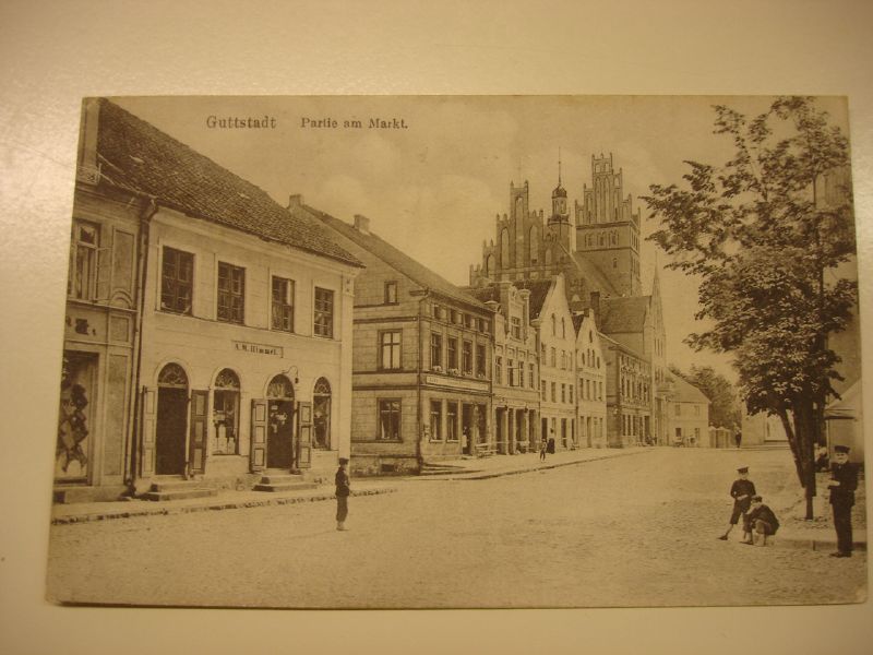 an old po of a town square with children and cars
