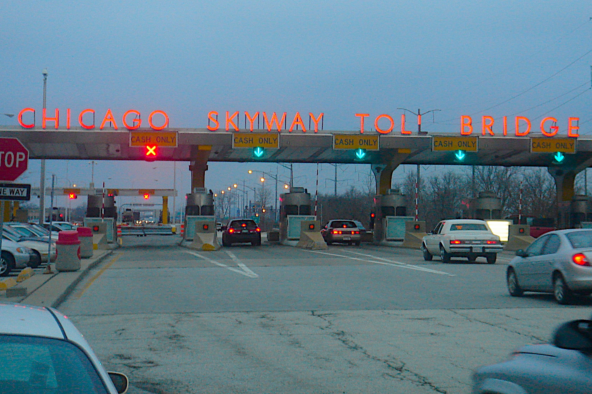 cars driving under an overpass on a city street