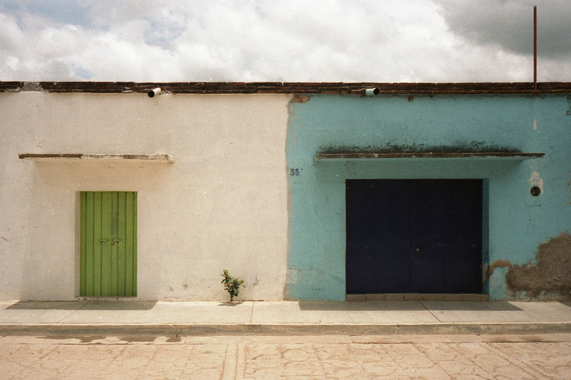 two brightly painted buildings sit side by side