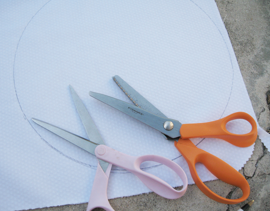 four pairs of scissors resting on white fabric