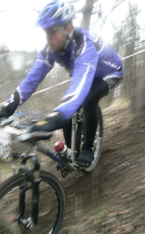 a man riding his bicycle in a forest