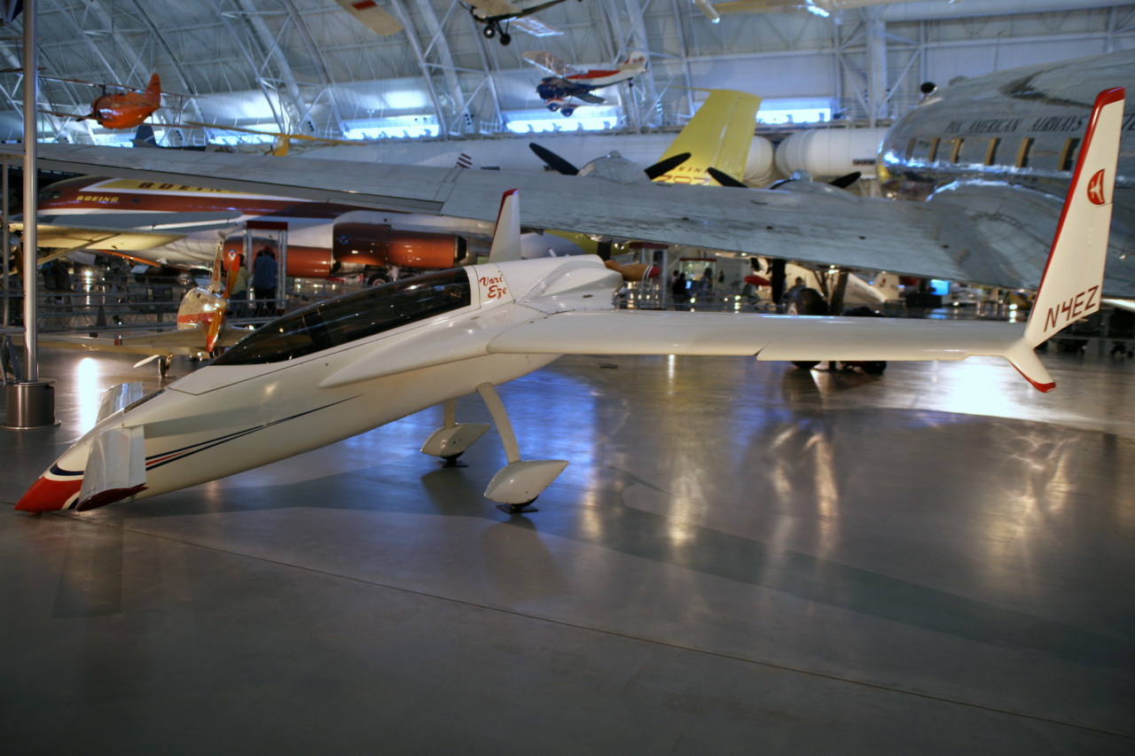 a small white airplane in a hanger at a museum