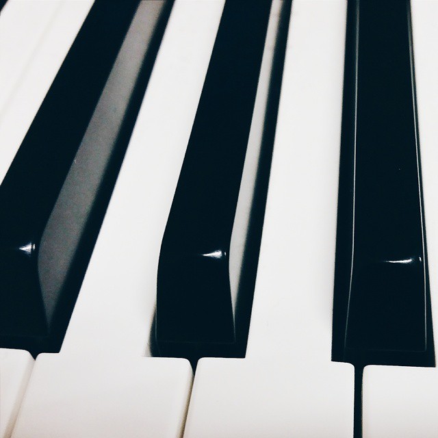 a black and white piano is laying down