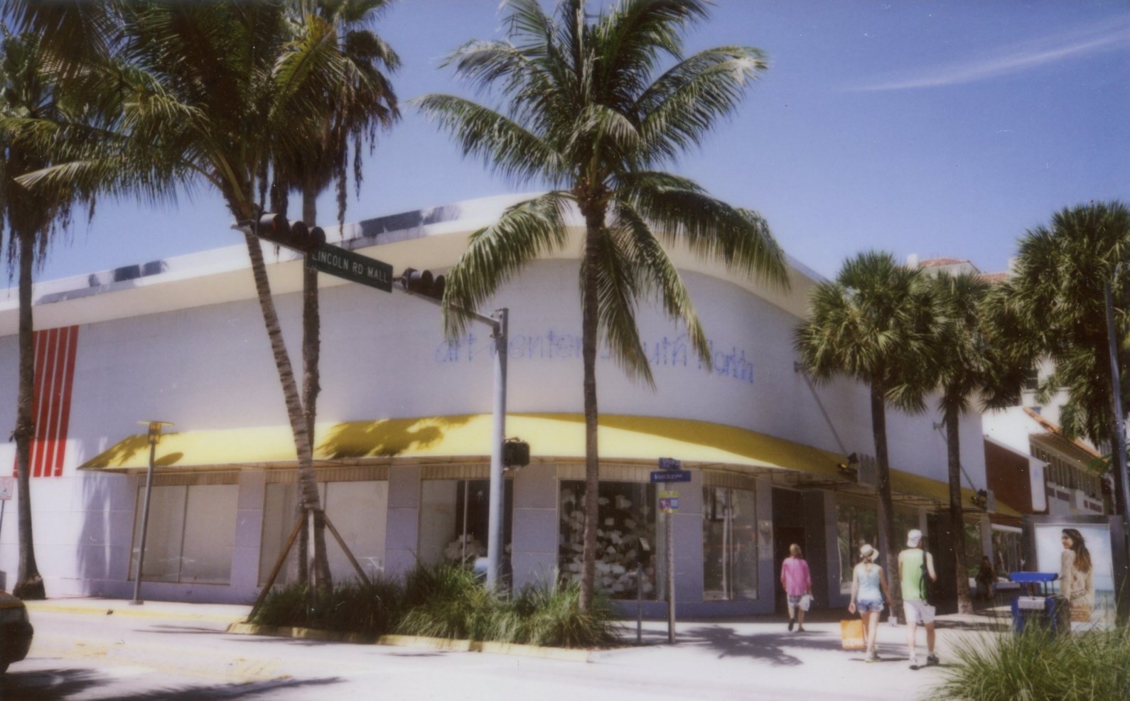 this building has a lot of windows and palm trees