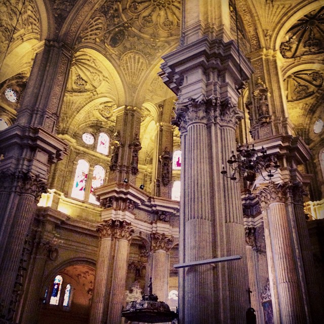 a stone and stone church with lights on